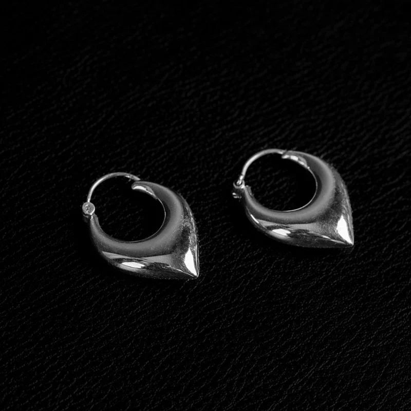 Chevron-shaped 925 sterling silver hoop earrings in medium size, showing gauge thickness and structural profile on a model.