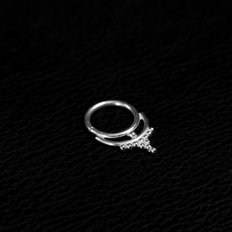 Crown-shaped 925 sterling silver septum ring, a small arched hoop edged with fine granulated bead detailing.
