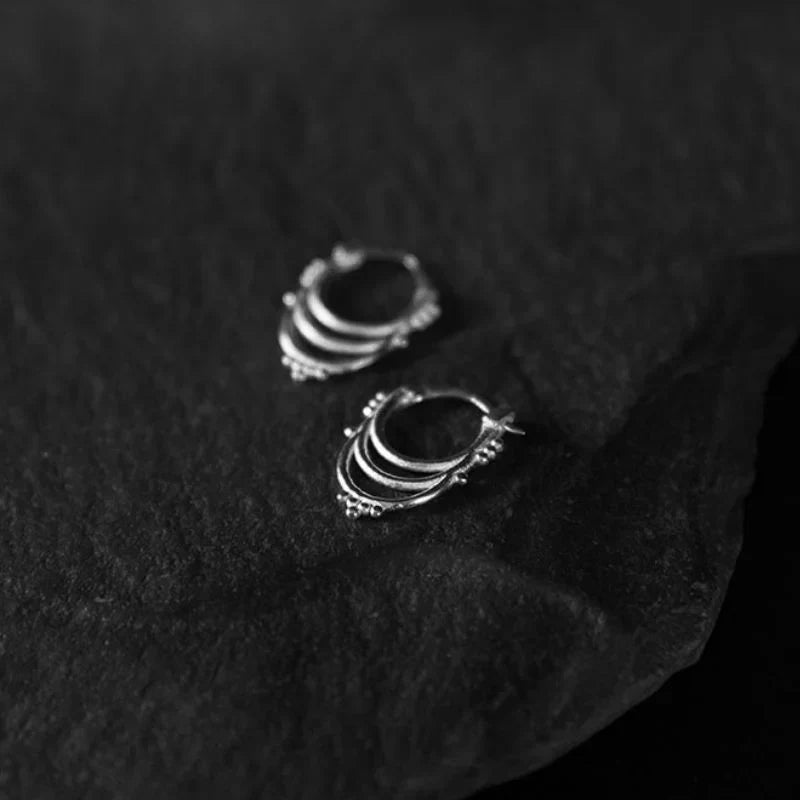 925 sterling silver beaded hoop earrings with granulation detail on the band, photographed to show hoop diameter and surface texture.