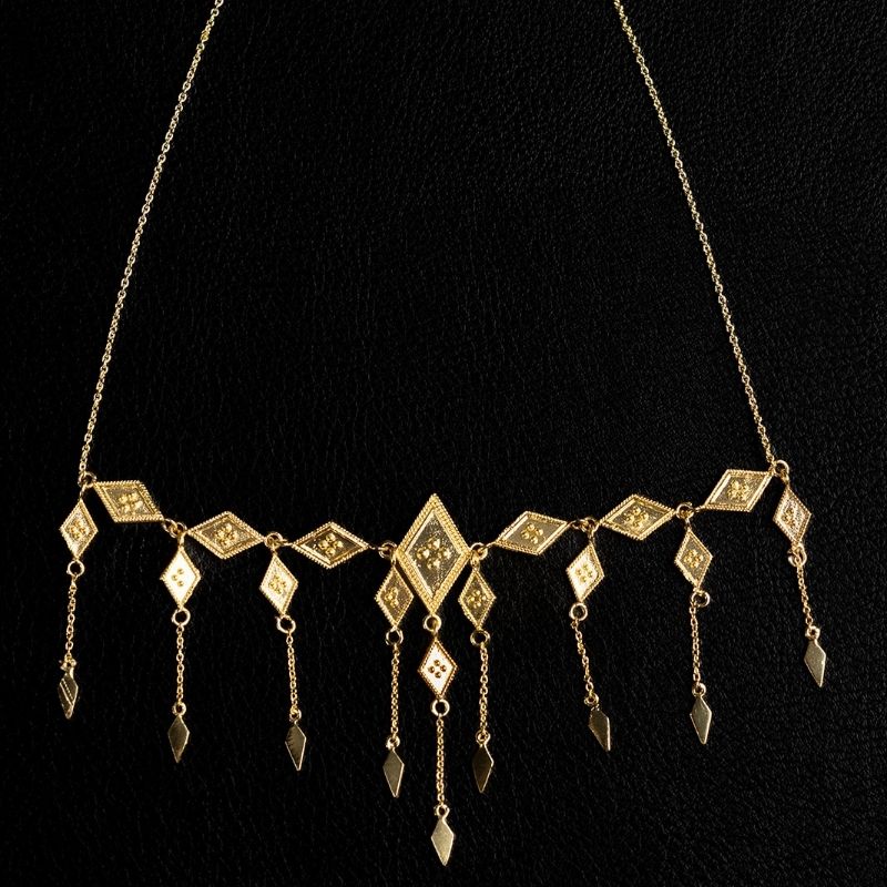 Brass diamond fringe necklace with engraved rhombus charms and dangling chain drops by Noir KĀLA.
